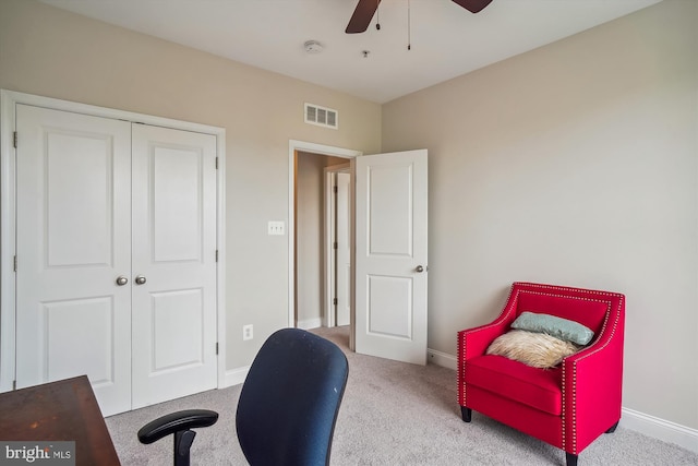 carpeted home office featuring ceiling fan