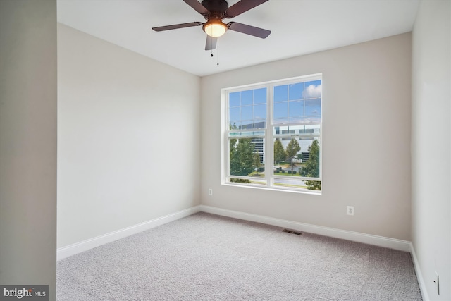 unfurnished room featuring ceiling fan and carpet floors