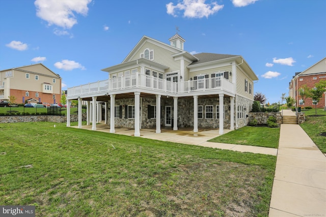 back of property featuring a yard, a patio, and a deck