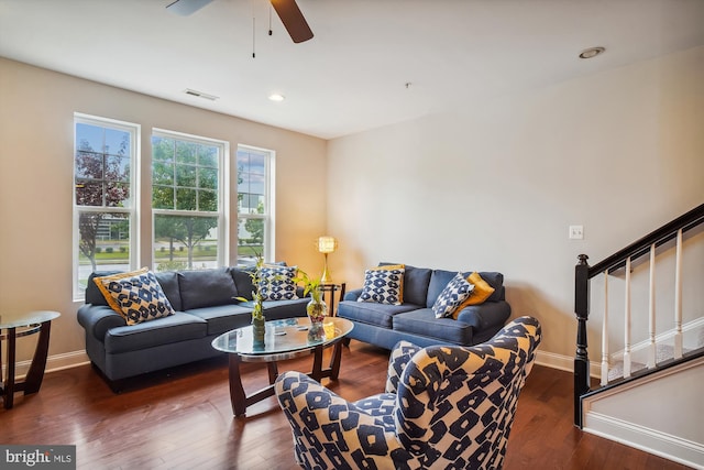 living room with dark hardwood / wood-style flooring and ceiling fan