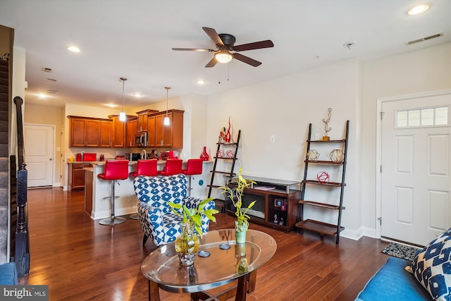 living room featuring dark hardwood / wood-style flooring and ceiling fan