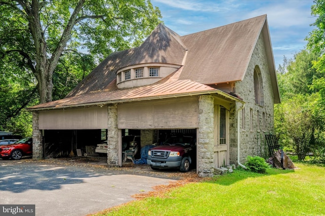 view of side of property with a garage and a lawn