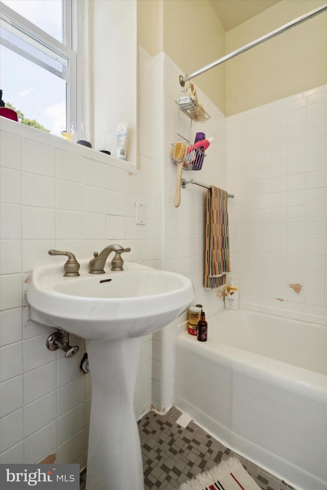 bathroom featuring tasteful backsplash, tile patterned floors, and tile walls