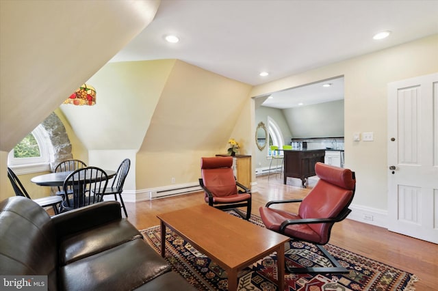 sitting room with a baseboard radiator, vaulted ceiling, and light hardwood / wood-style floors