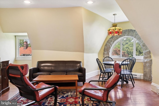 living room with hardwood / wood-style floors, lofted ceiling, and a healthy amount of sunlight