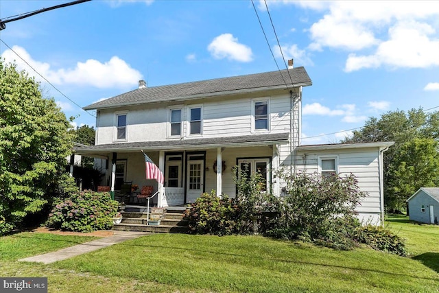 view of front facade with a front yard and a porch