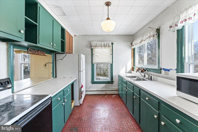 kitchen featuring white appliances, a baseboard radiator, green cabinets, and sink