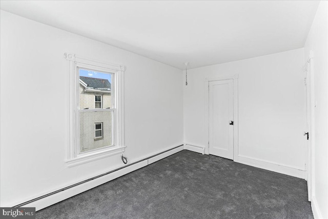 unfurnished room featuring a baseboard radiator and dark carpet