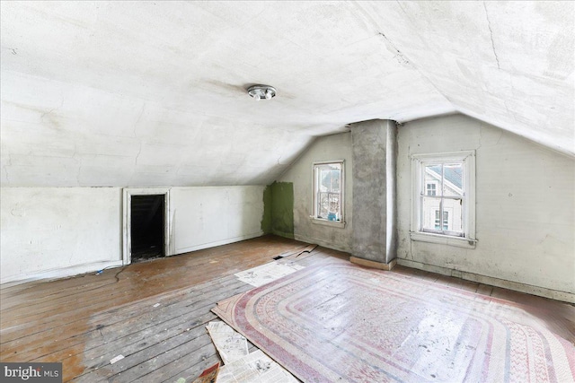 bonus room featuring wood-type flooring and vaulted ceiling