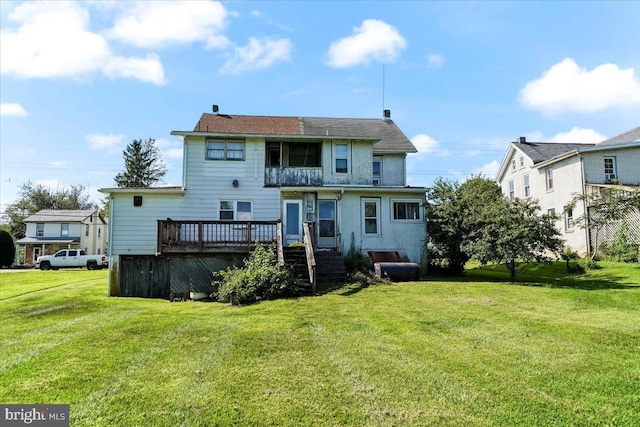 back of house featuring a yard and a deck