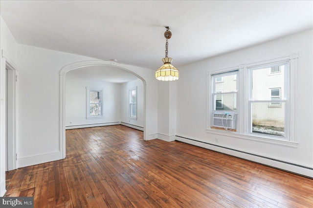 unfurnished dining area featuring cooling unit, dark hardwood / wood-style flooring, and baseboard heating