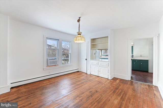 unfurnished dining area with dark wood-type flooring, cooling unit, and a baseboard radiator