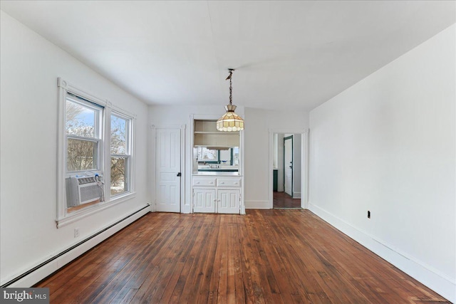 unfurnished dining area with cooling unit, dark hardwood / wood-style floors, and a baseboard heating unit