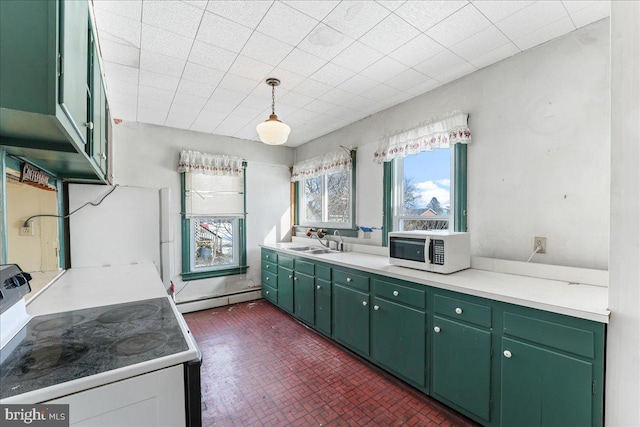 kitchen featuring range, green cabinetry, a baseboard heating unit, and sink