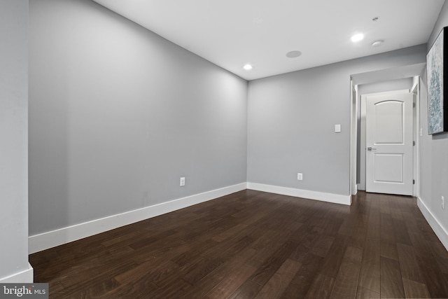 unfurnished room featuring dark hardwood / wood-style flooring