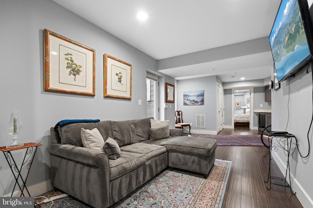 living room with dark hardwood / wood-style flooring