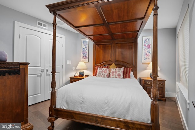 bedroom featuring a closet and dark wood-type flooring