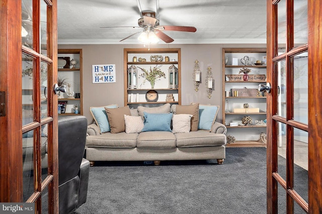 living room featuring ceiling fan, ornamental molding, a textured ceiling, and dark colored carpet