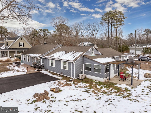 view of snow covered rear of property