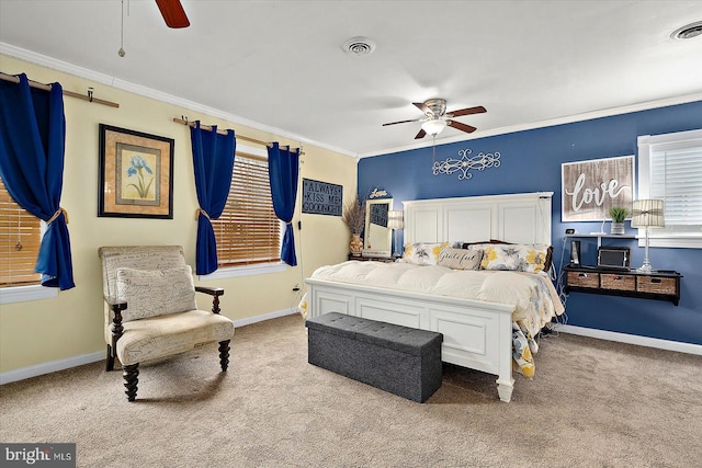 carpeted bedroom with ceiling fan and ornamental molding