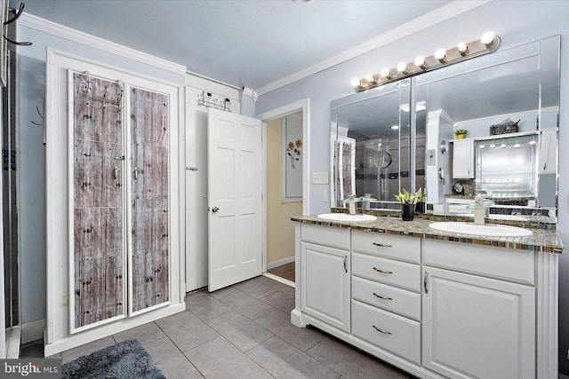 bathroom with crown molding, tile patterned floors, and vanity