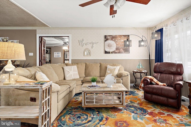 living room with ceiling fan and ornamental molding