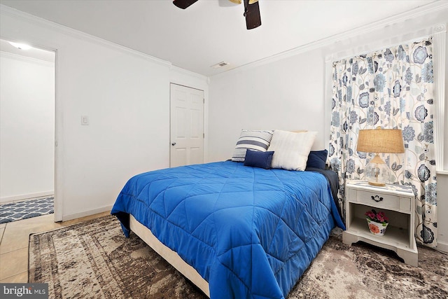 bedroom featuring ceiling fan and ornamental molding