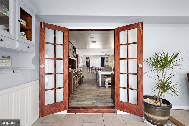 doorway to outside featuring ceiling fan, light tile patterned flooring, and french doors