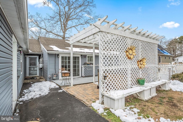 wooden deck with a pergola and a patio