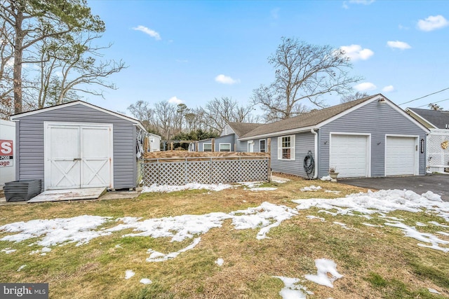 view of yard featuring a garage and a storage unit