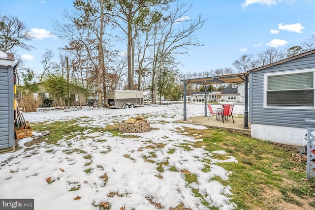 snowy yard featuring an outdoor fire pit