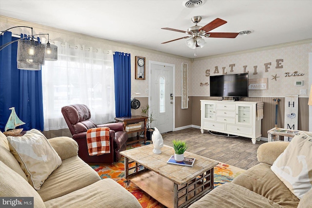 living room with ceiling fan, hardwood / wood-style floors, crown molding, and a healthy amount of sunlight