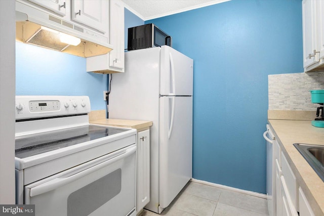 kitchen featuring light tile patterned flooring, white appliances, white cabinetry, and backsplash