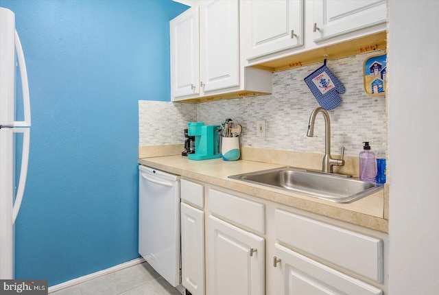 kitchen with white cabinetry, white appliances, sink, and tasteful backsplash