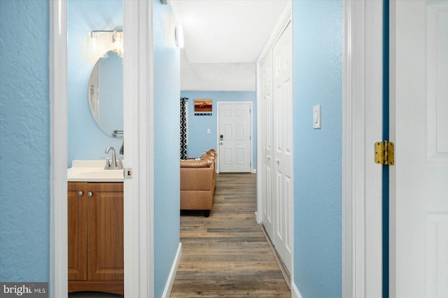 hall featuring dark hardwood / wood-style flooring and sink