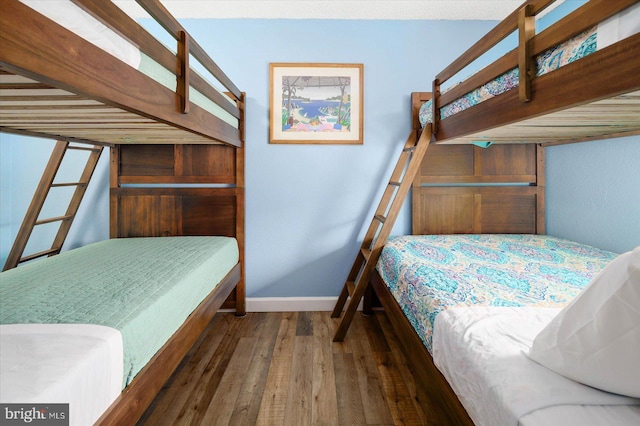 bedroom with dark hardwood / wood-style flooring