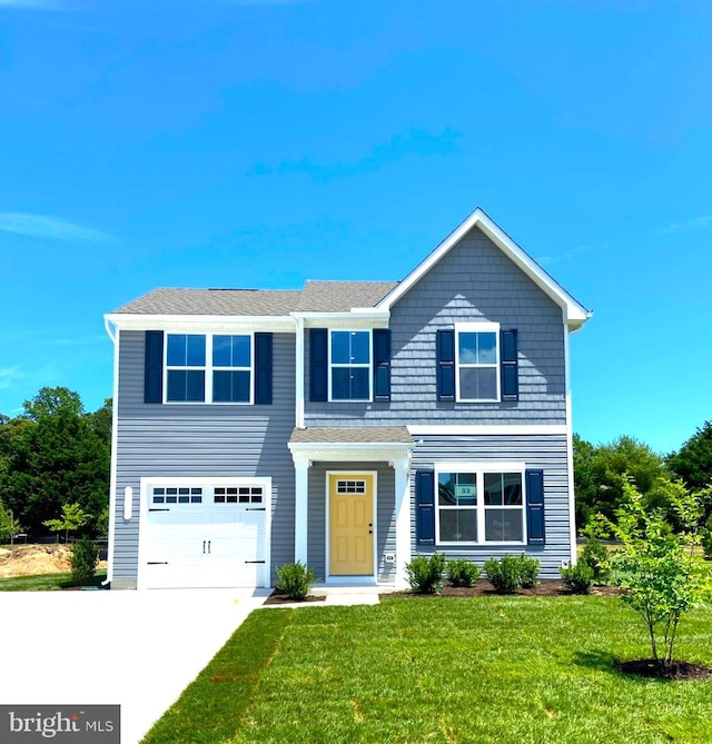 view of front of house with a front lawn and a garage