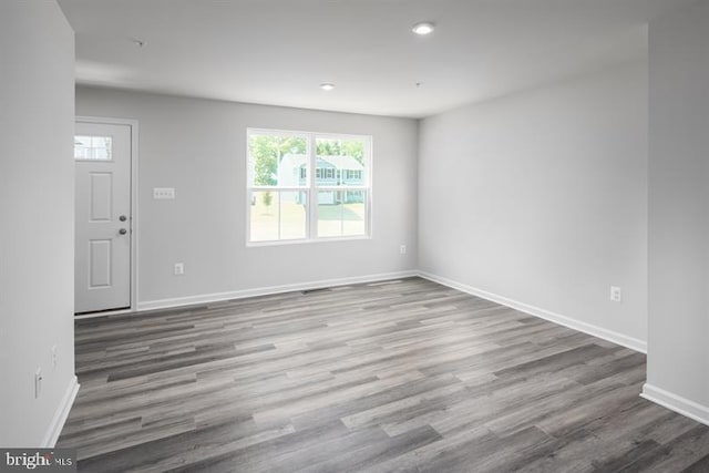 unfurnished room with hardwood / wood-style flooring