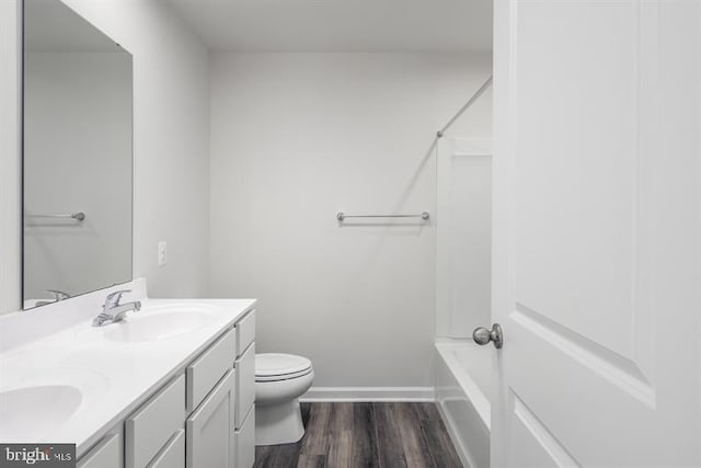 bathroom with vanity, hardwood / wood-style flooring, and toilet