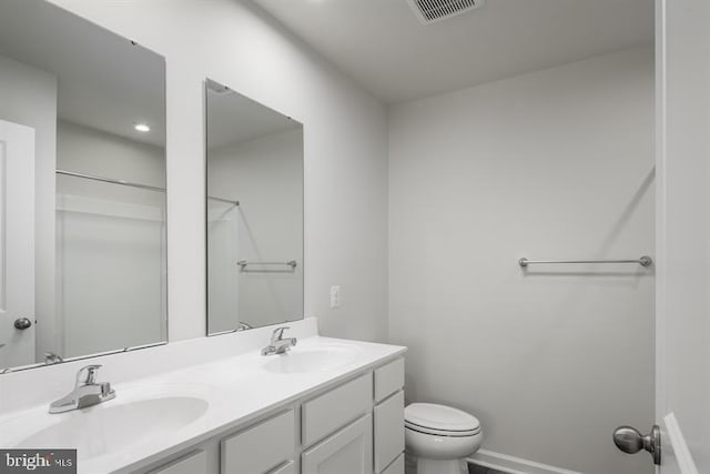 bathroom featuring vanity and toilet