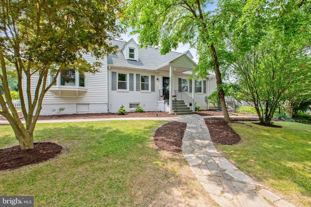 cape cod home featuring a front yard