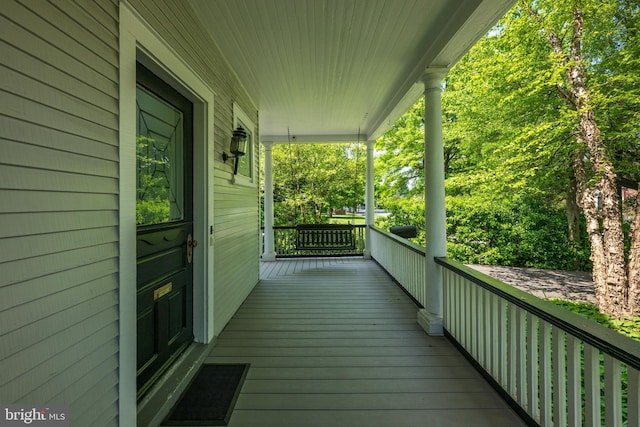 wooden terrace featuring covered porch