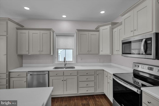 kitchen featuring white cabinets, sink, appliances with stainless steel finishes, and dark wood-type flooring