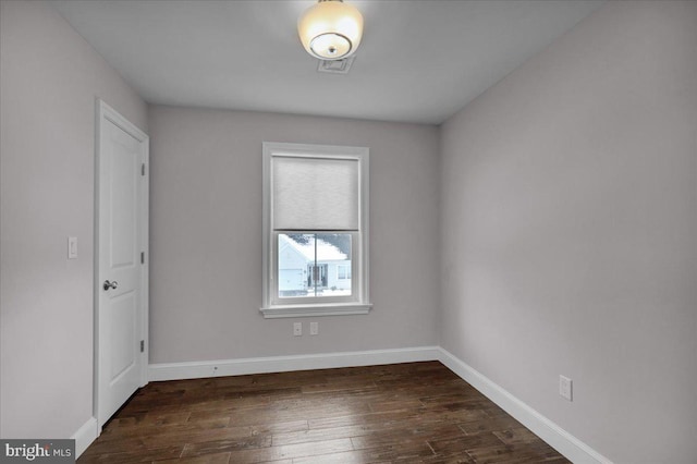 spare room featuring dark hardwood / wood-style flooring