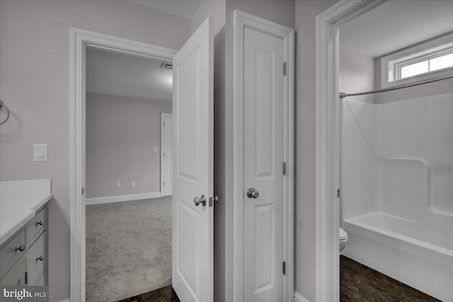 full bathroom featuring vanity, bathtub / shower combination, and toilet