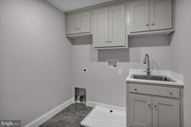 washroom featuring washer hookup, electric dryer hookup, cabinets, and sink