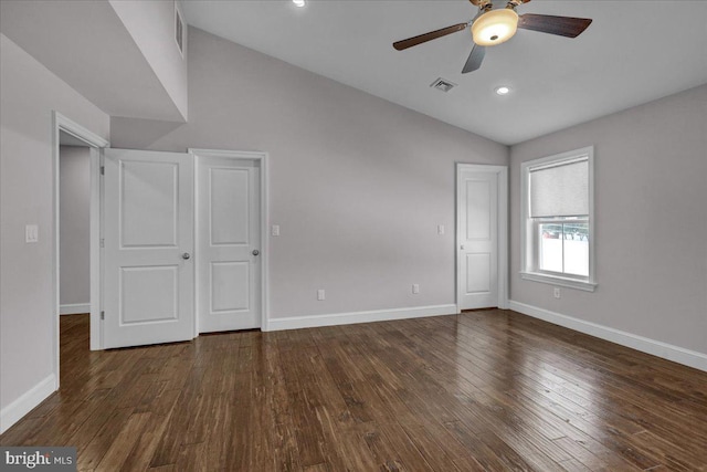 unfurnished bedroom with dark hardwood / wood-style flooring, vaulted ceiling, and ceiling fan