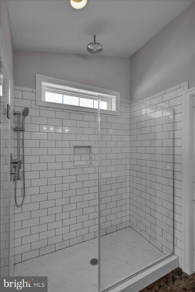 bathroom with tiled shower