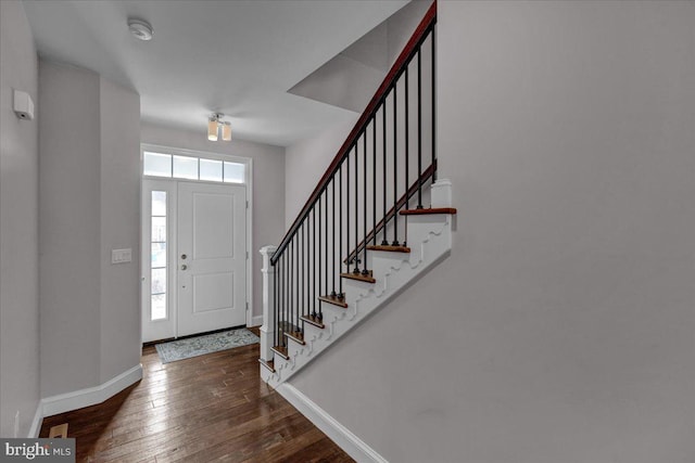 foyer with dark hardwood / wood-style flooring and a healthy amount of sunlight