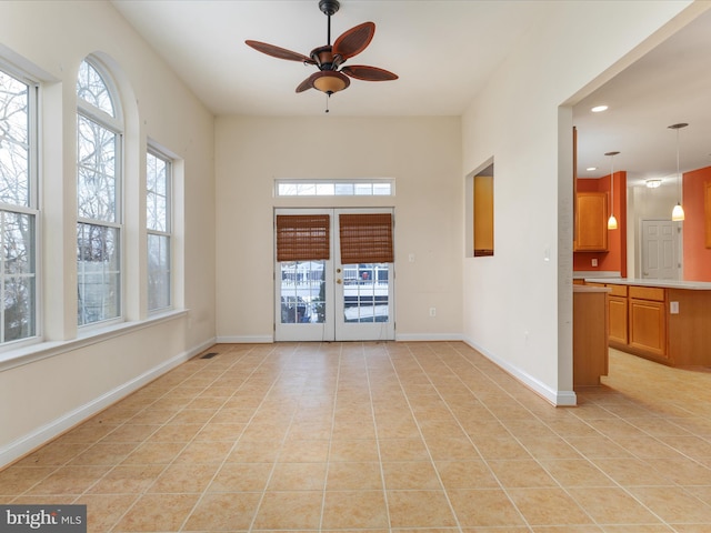 spare room featuring ceiling fan, light tile patterned floors, and french doors